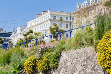 Colorful flowers in front of the buildings along the seaside in Eastbourne, Sussex, United Kingdom