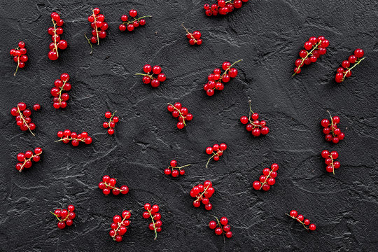 Berry pattern. Red currant on black table background top view.