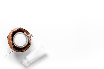 Body treatment. Coconut oil and cream on white background top view copyspace