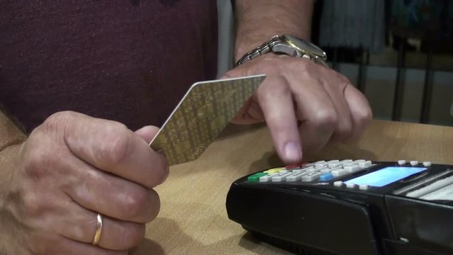 Man's hand holding a credit card for the payment terminal. HD 1920x1080 Video Clip