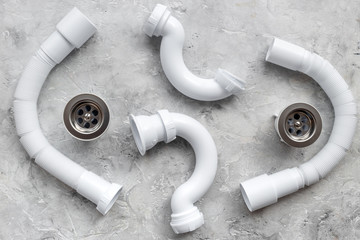 Clear clogged sink drains. Parts on grey stone background top view