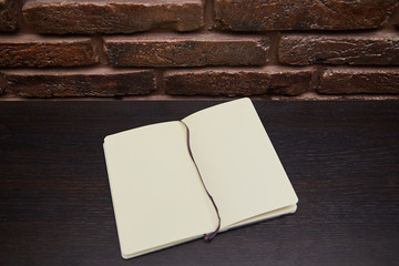 Open Notepad or sketchbook lying on background