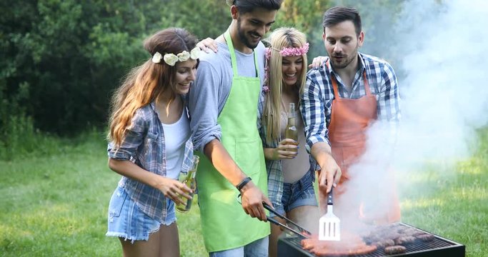 Friends spending time in nature and having barbecue