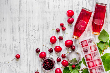 Ice cranberry morse with cherry and pulm on wooden table top view copyspace © 9dreamstudio