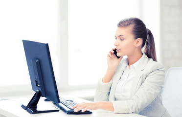 businesswoman with smartphone in office