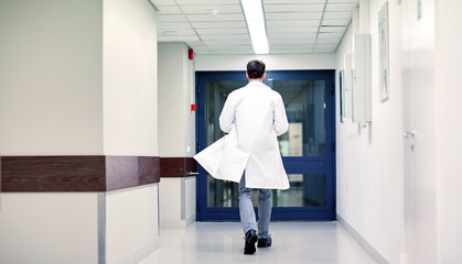 medic or doctor walking along hospital corridor