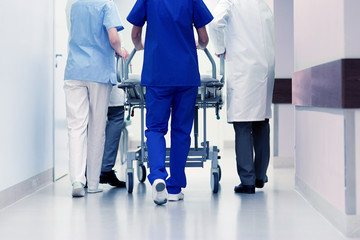 medics carrying hospital gurney to emergency room