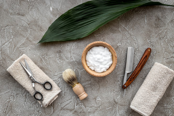 Fototapeta na wymiar Preparing for men shaving. Shaving brush, razor, foam, sciccors on grey stone table background top view