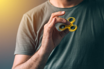 Man playing with fidget spinner