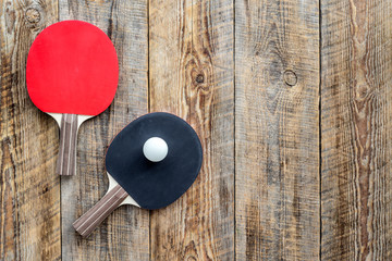 Sport background. Table tennis racket on wooden background top view copyspace