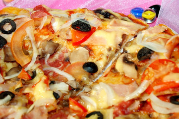 Pizza with cheese, tomatoes, sausage, black olives and mushrooms