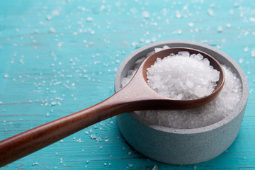 sea salt in stone bowl and wooden spoon