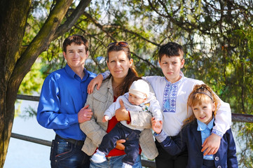 The whole family is walking around the river