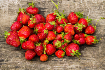 Ripe fresh strawberries on rustic wooden background. Top view