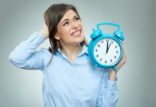 Business woman holding alarm clock.