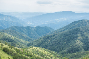Obraz premium Green mountain landscape. Beautiful look at the mountain valley from the top of the hill.