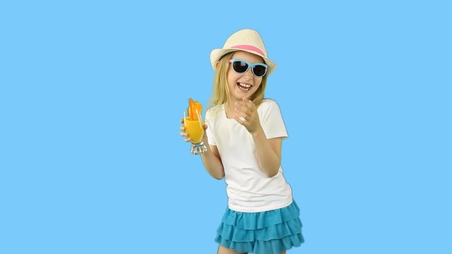 Young caucasian girl walking and drinking orange juice. Thumbs up gestures show.