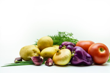 Assortment of fresh raw vegetables on white background. Selection includes potato, tomato, green onion, pepper, garlic and dill