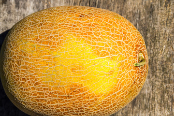 Ripe whole melon on old wooden table