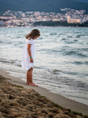 Little girl on sea coastline