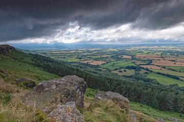 Fototapeta na wymiar Storm clouds over the Cleveland Way at Wain Stones in North Yorkshire Moors National Park. The industrial town of Middlesbrough is on the horizon. 