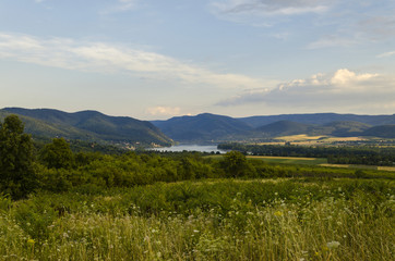 river in distance scenic summer green landscape of hills 