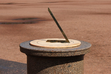A sundial on a pedestal made of pink granite in the 17th century before the Gatchina Palace