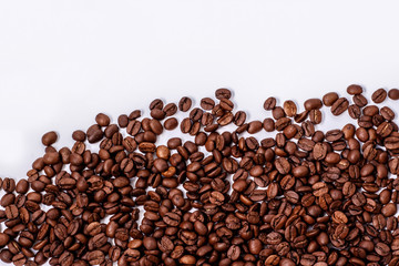brown coffee beans scattered on white background