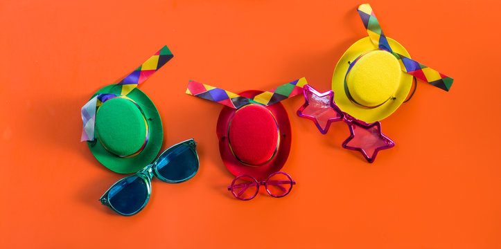 Colorful carnival hats on an orange background