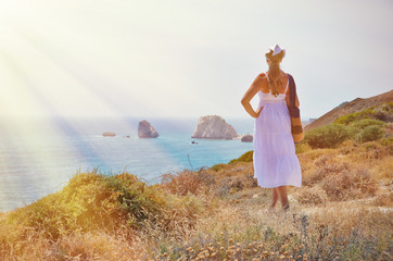 Fototapeta na wymiar Girl looking to the sea near Aphrodite birthplace, Cyprus