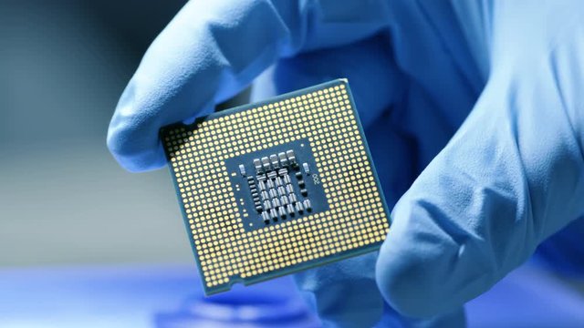 Close-up Presentation of a New Generation Microchip. Gloved Hand Holding Piece of Technological Wonder. Shot on RED EPIC-W 8K Helium Cinema Camera.