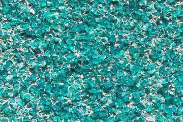 Part of the wall covered with small pieces of glass or quartz sea green.