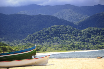 Ilhabela Sao Paulo, Brazil. Boats on the beach with mountains that meet the sea in the background. This island is a popular tourist destination. 