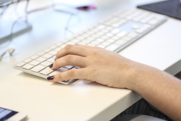 Close up of a female hand typing on keyboard