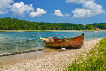 Naklejka na ściany i meble Boat on the coast of Black Lake