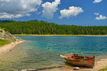 Naklejka na ściany i meble Boat on the coast of Black Lake