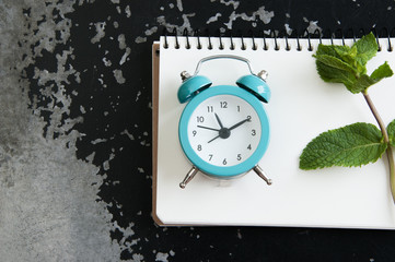 Turquoise alarm clock on black