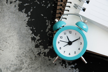 Turquoise alarm clock on black