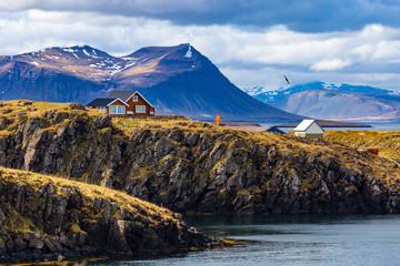 Typical Icelandic landscape with houses against mountains in small village of Stykkisholmur, Western Iceland - 165016652
