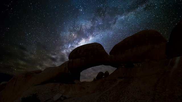 The summer Milky Way rises over the stone arch of Spitzkoppe in Namibia. The Milky Way is the galaxy that contains our Solar System.