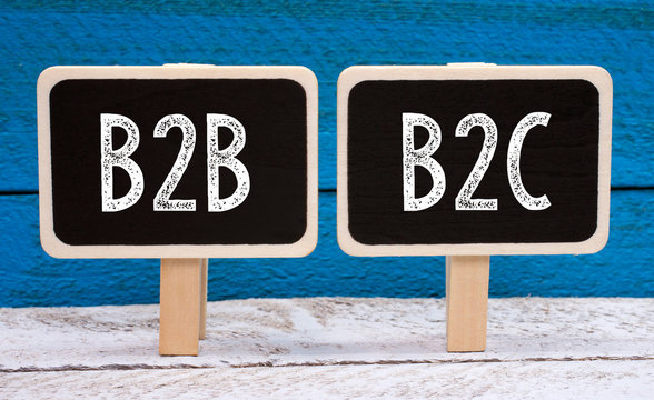 B2B and B2C Business - two little chalkboards with text on blue wooden background