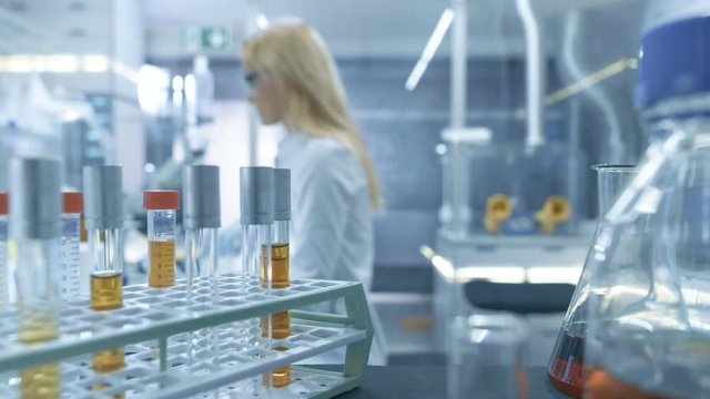 Point of View Shot From a Moving Cart with Test-Tubes, Analysis, Beakers and Various Glassware. Scientist Puts Some of Test-Tubes on a Cart.Shot on RED EPIC-W 8K Helium Cinema Camera.