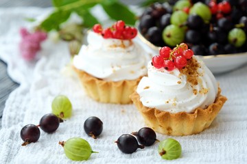 Delicious cakes with cream and berries