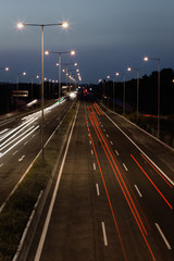 Fototapeta na wymiar Long exposure of traffic cars lights at night on a highway