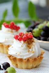 Delicious cakes with cream and berries