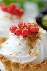 Delicious cakes with cream and berries