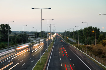 Car traffic lights at evening on a highway