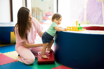Baby maintaining balance in early stimulation therapy