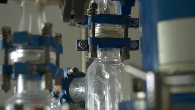 Liquid flows through a transparent pipe. Experience in chemical laboratory
