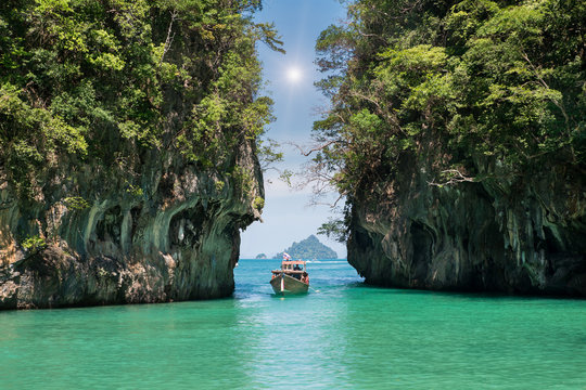 Fototapeta Beautiful landscape of rocks mountain and crystal clear sea with longtail boat at Phuket, Thailand. Summer, Travel, Vacation, Holiday concept.